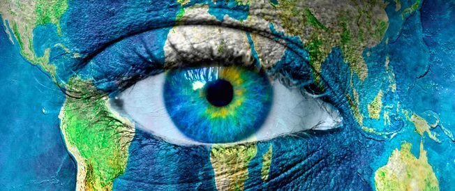 A human eye painted with a map of the world